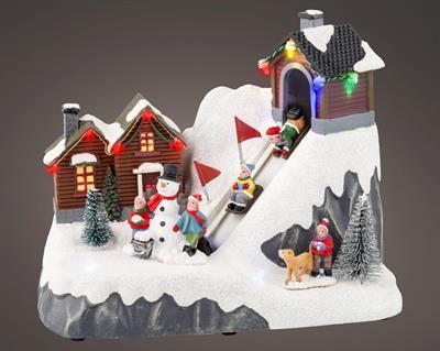 VILLAGGIO DI NATALE CON PISTA ANIMATA 13X21,5X17CM